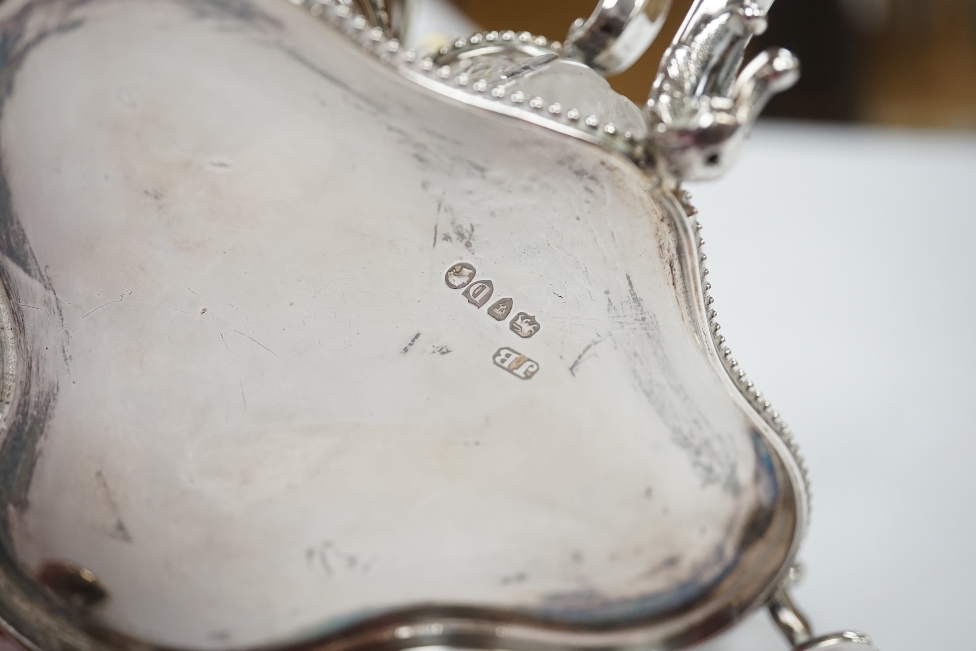 A late Victorian silver cruet stand, Jane Brownett, London, 1879, with four silver mounted bottles, different maker, Birmingham, 1879, height 67mm, together with a later silver mustard pot, a George V silver mounted phot